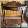 F07. Demilune tiered console table with inlay. 